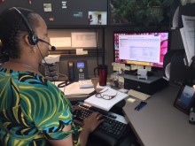 I-9 Compliance Analyst Valier Anyaogu assists a store with I-9 questions.
