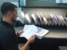 Record Support Wayne Fernandez prepares documents to be scanned into associates' electronic personnel files.