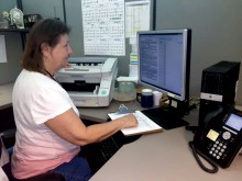 Leave specialist Colleen Scouras scans associates documents into our online management system. 