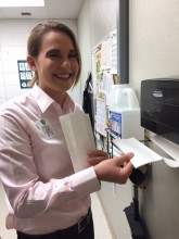 Customer Service Team Leader Kayla Scholz encourages associates to fill the paper towels and first air kits daily.