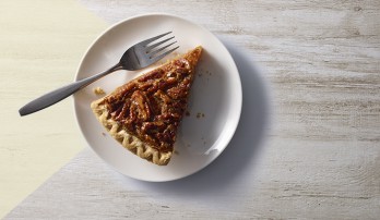 A slice of pecan pie on a white plate