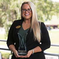 Ms. Danielle Dufresne-Lone Palm holding her community award