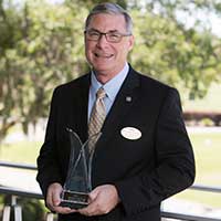 Mr. Greg Rogolino-Lone Palm holding his community award