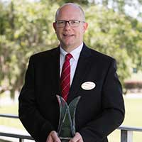 Mr. Mike Skehan-Lone Palm holding his community award