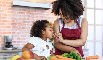 Mother and child eating vegetables