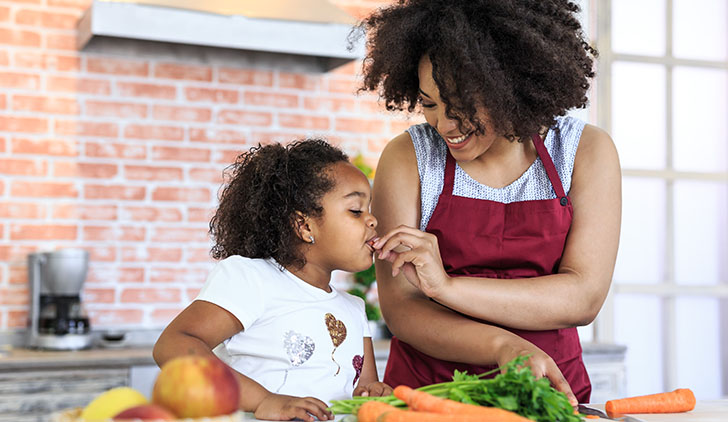 Mother and child eating vegetables