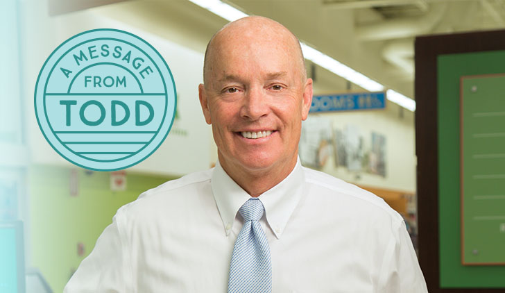 Publix CEO Todd Jones, portrait in store in a white shirt with a blue spotted tie, and a message stamp that reads "A Message from Todd"