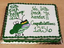 Cake with the words Bite Back Challenge 2019 - We bite back 4x harder!! Congratulations 1256 and the image of the cartoon flu bug