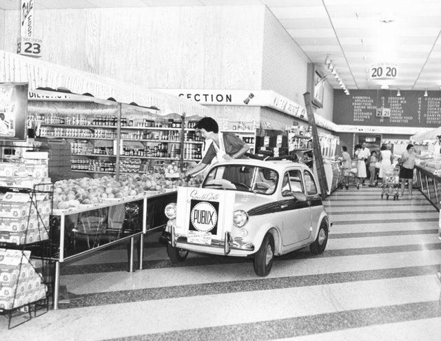 These aisles are wide! A car drives through a Publix store.